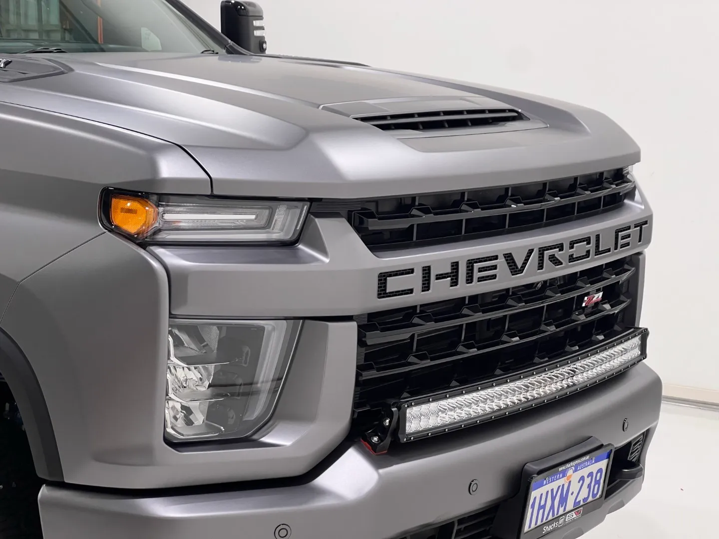 Matte grey wrapped Chevrolet Silverado front end in the workshop