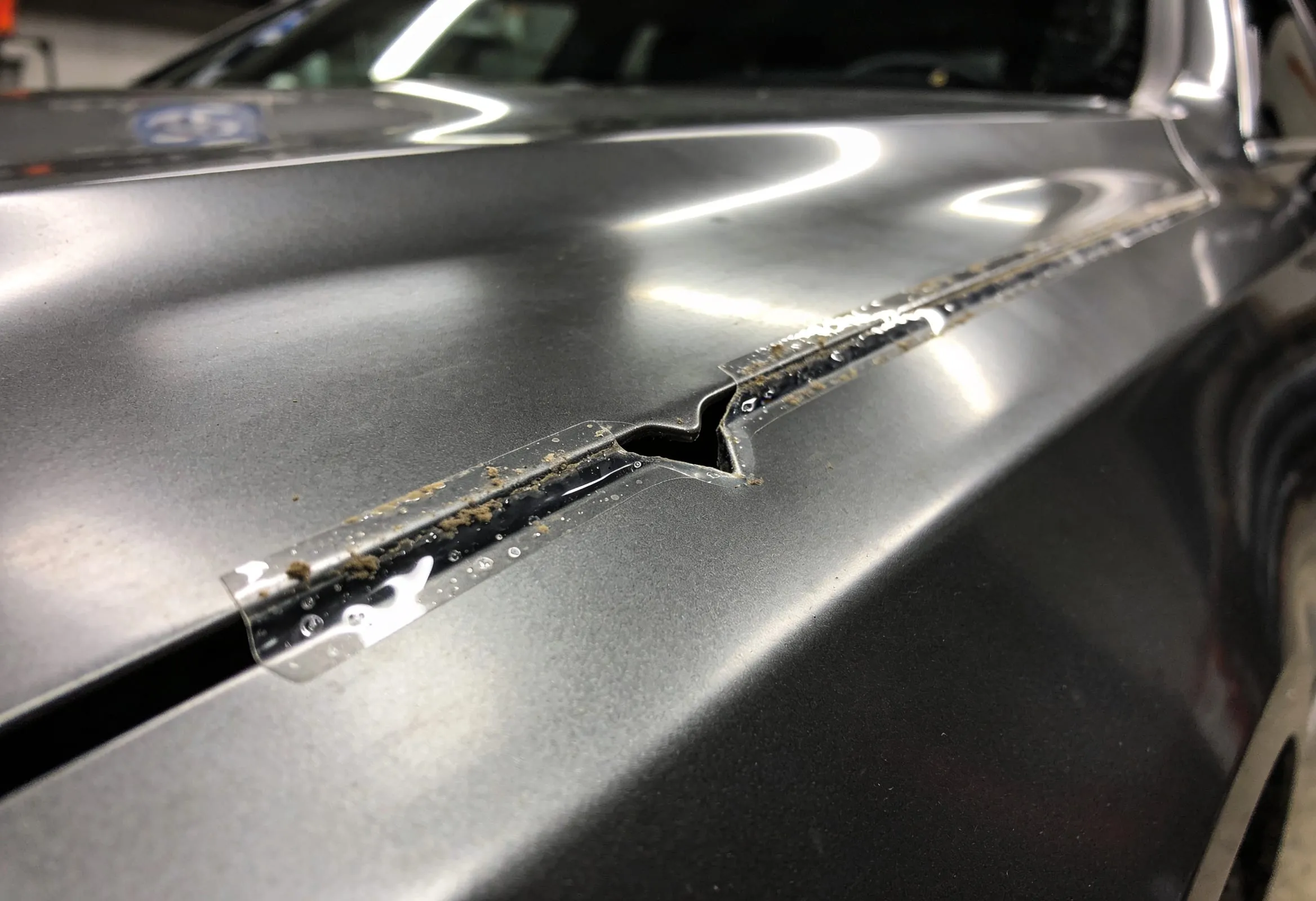 Typical budget shop install - film cut short of the panel edge, collecting dirt along a visible line