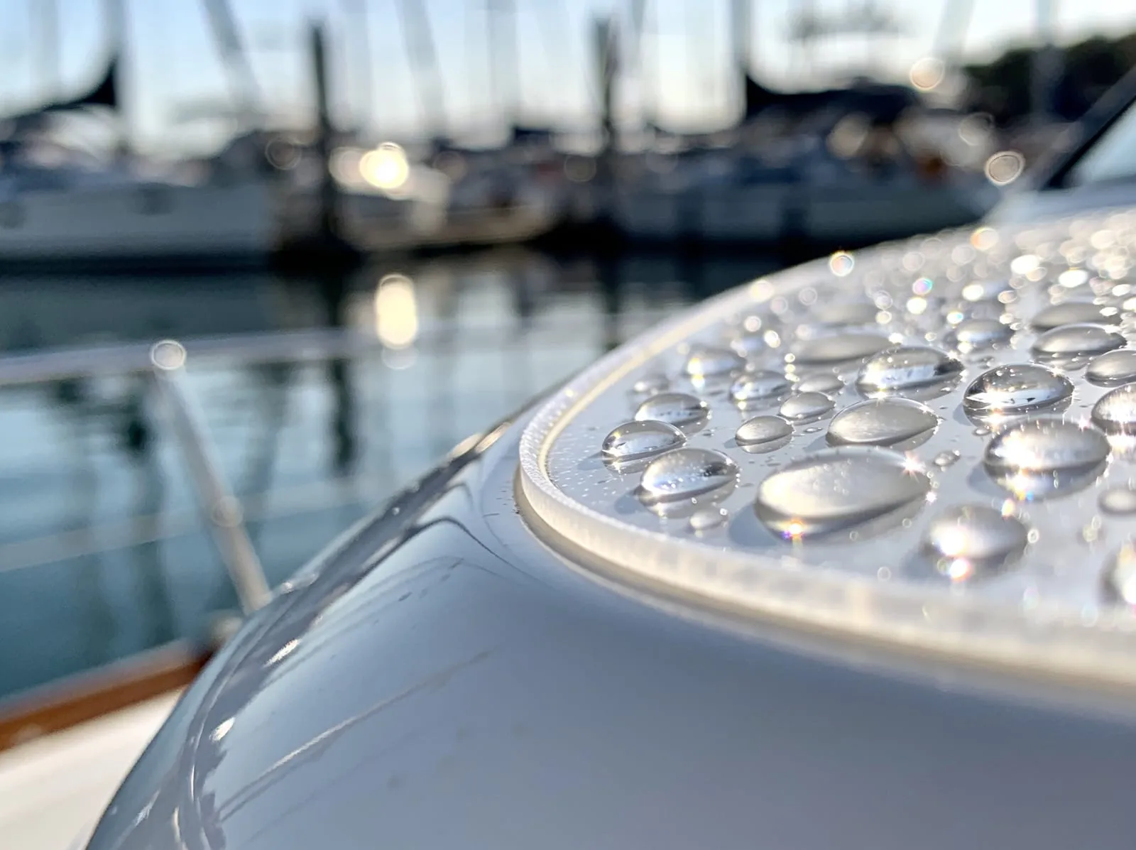 Water beading on clear protection film on a boat bow at the marina